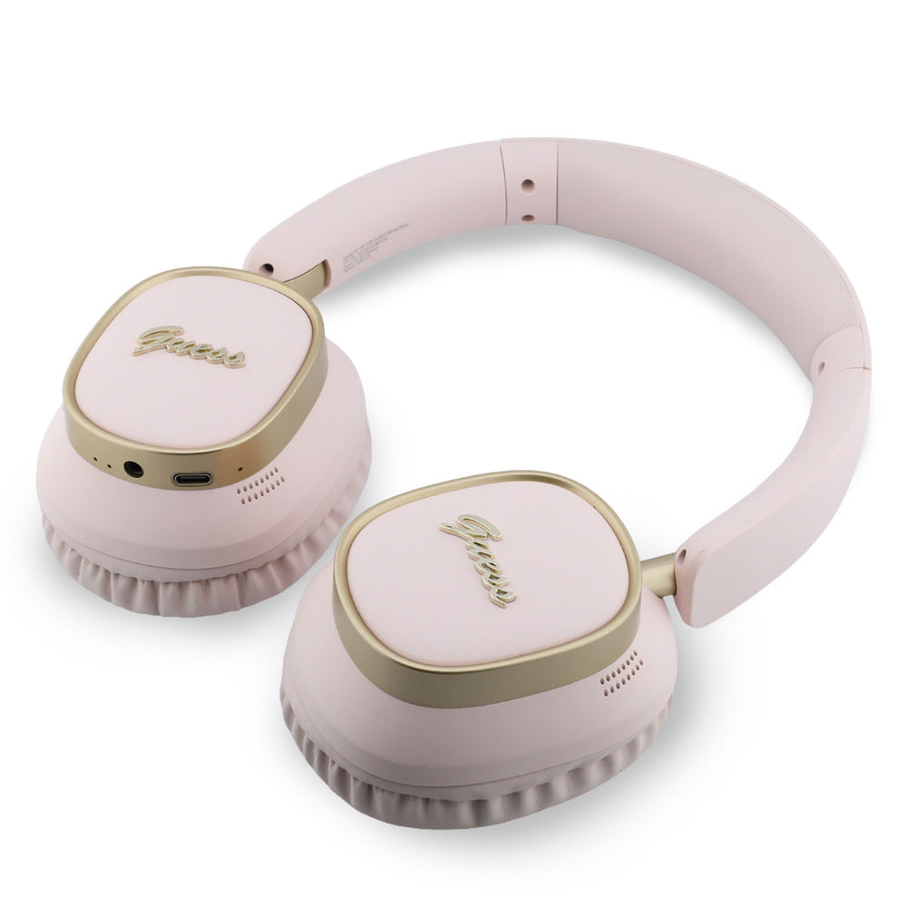 Roze Guess koptelefoon liggend met oorschelpen naar boven