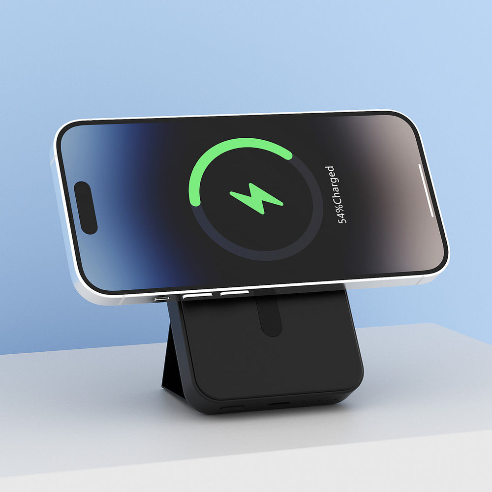 Zwarte TUNIQ powerbank als standaard voor een horizontale telefoon